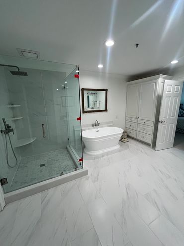 Vinings master bathroom after remodeling: new freestanding tub, custom shower, and storage cabinets