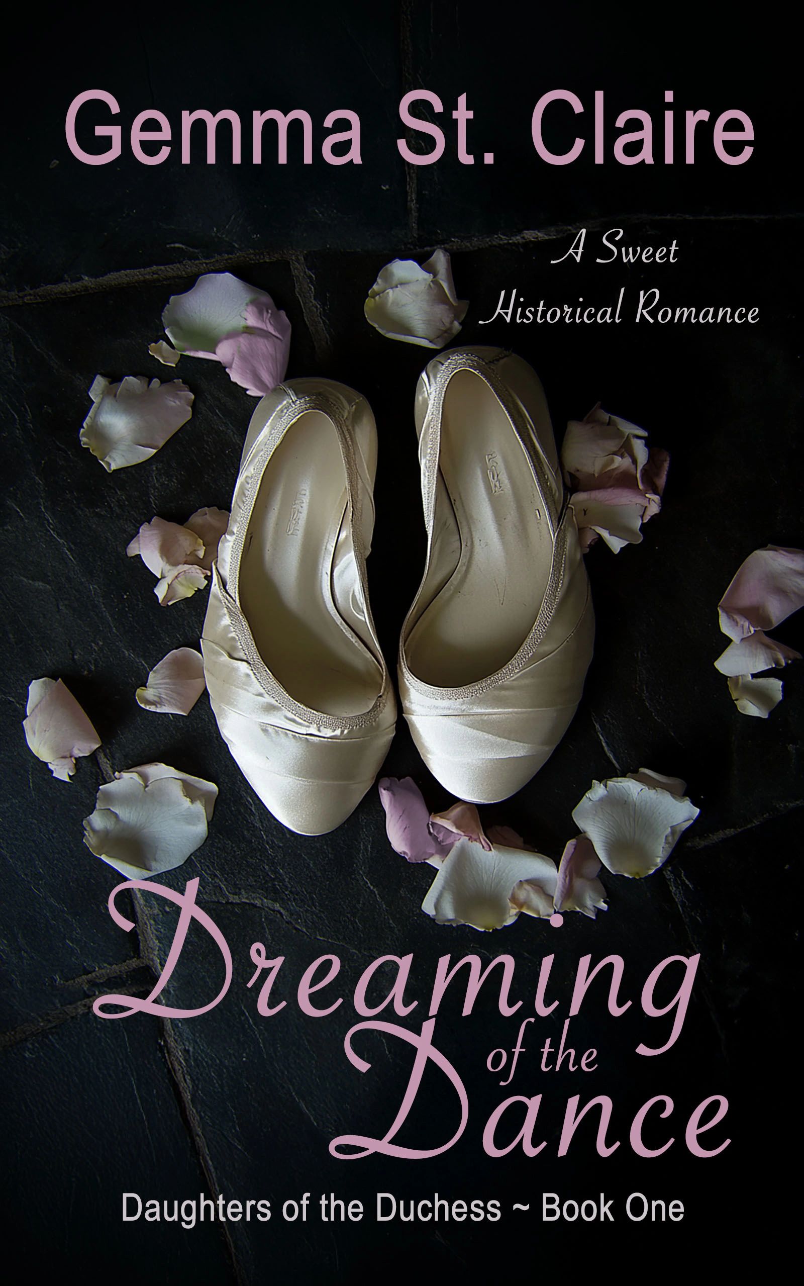 A pair of white dancing slippers on a stone floor surrounded by rose petals.