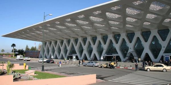 Modern airport terminal with distinctive lattice design.