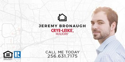 Jeremy Bronaugh, Realtor with Crye-Leike Reators, standing against a map of Huntsville, Alabama.