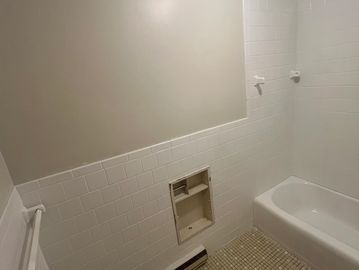 Tile reglaze to bright white from yellow and a bathtub from pink to white for a more modern look!