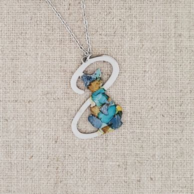 Pendant necklace with a colorful cat design.