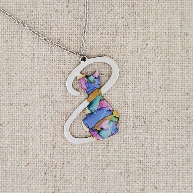 Colorful cat pendant on a silver chain.