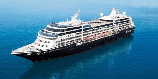 A large cruise ship sailing on calm blue ocean waters.