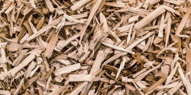 Close-up of light brown wood chips scattered randomly.