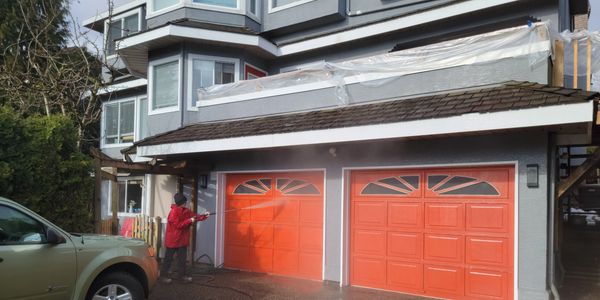 Pressure washing a house.