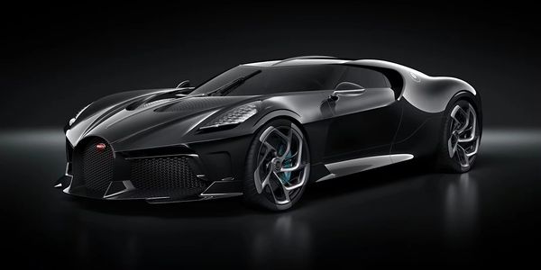 Sleek black Bugatti sports car with futuristic design and sharp lines.