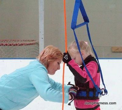 Figure skater using jump training harness