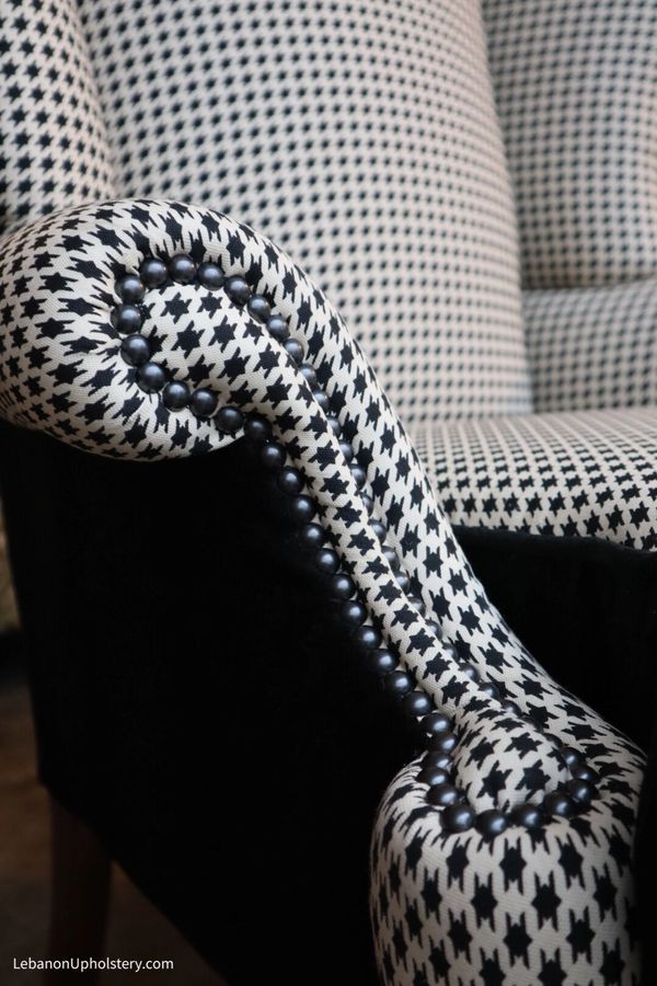 Classic upholstery: houndstooth and black velvet wingchair with black pearl decorative nails.