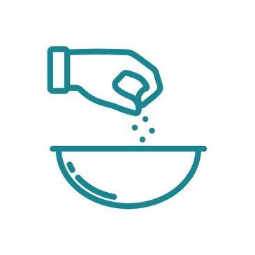 Hand sprinkling salt or seasoning into a bowl.