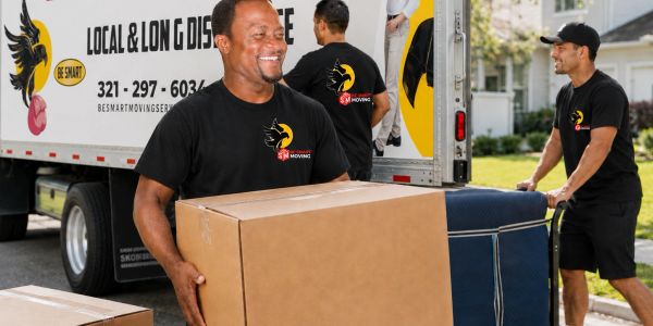 Movers carrying boxes from a moving truck.