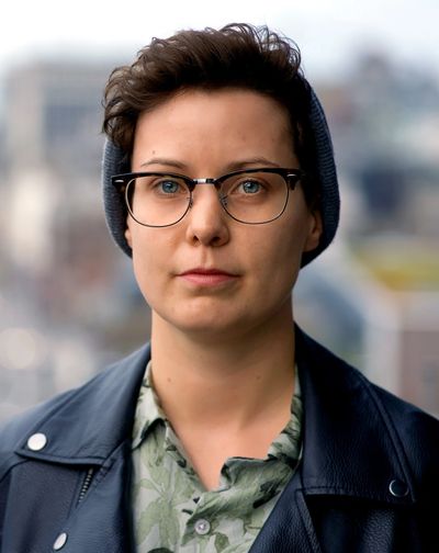 Person looking straight at camera wearing a hat and glasses.