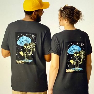 Couple wearing black t-shirts with alien and pizza design on the back.