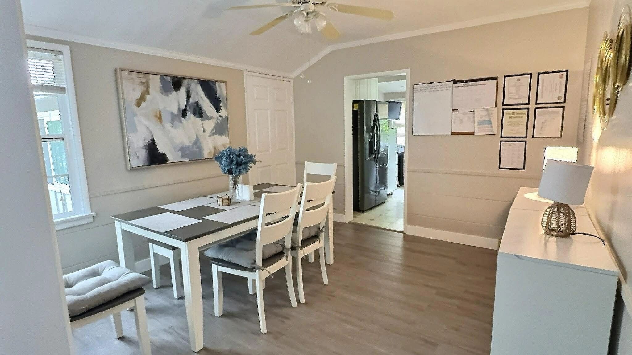 Bright dining area with white furniture and modern decor.