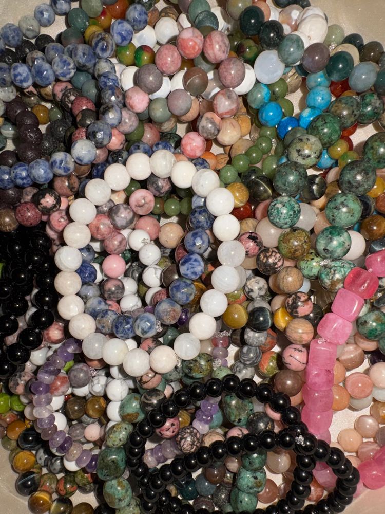 Colorful beaded bracelets made from various stones and crystals.