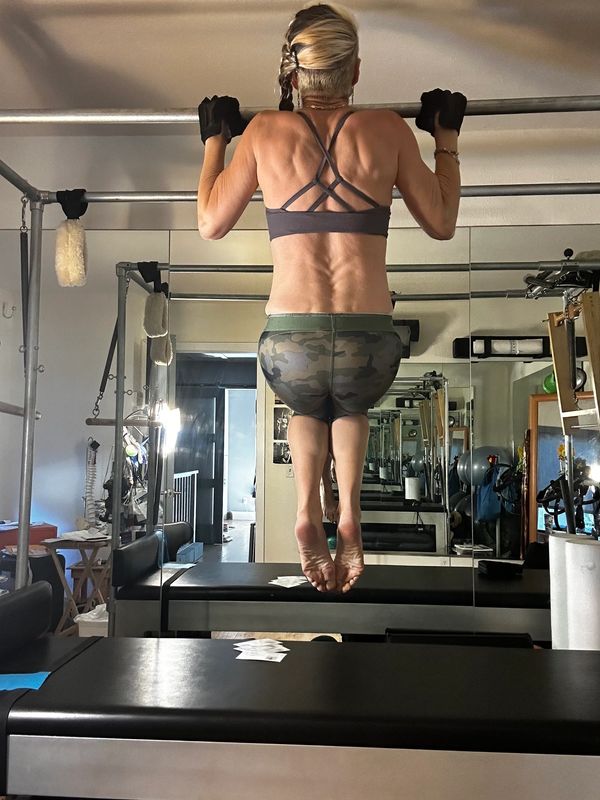 Woman doing pull ups on the display