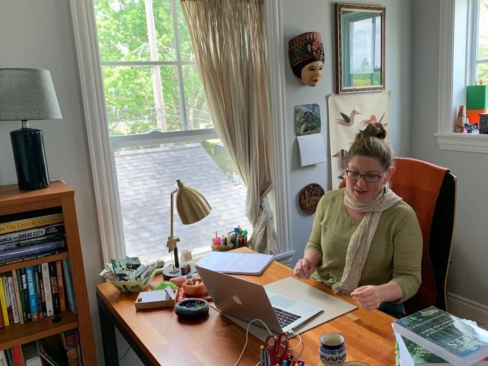 Ann Bueche in her office working at the computer.