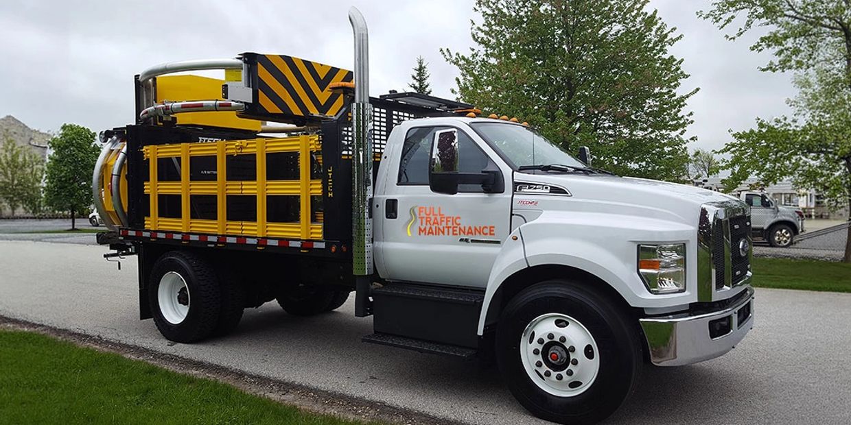 A white traffic maintenance truck parked on a road.