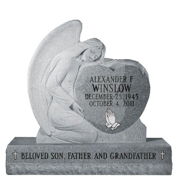 Angel statue embracing heart-shaped tombstone for Alexander F. Winslow.