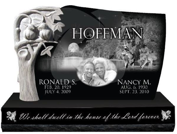 Engraved black granite tombstone with portraits and nature design.
