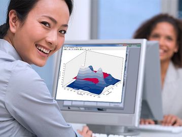 Woman smiling at camera with 3D graph on computer screen.