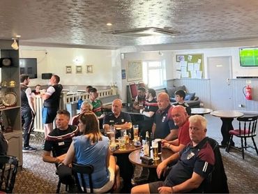 The Irish Club regulars watching the GAA on TV.