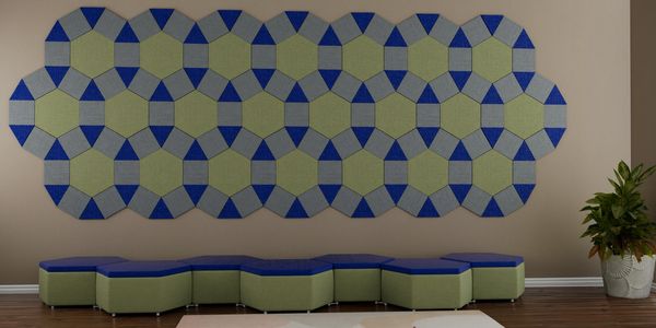 Geometric wall art and matching modular ottoman seating in blue and green.