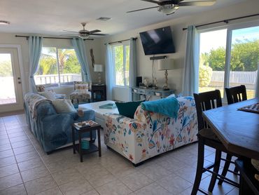 Living room with tropical decor, 50" Samsung flat screen smart tv, fibre optic highspeed internet. 