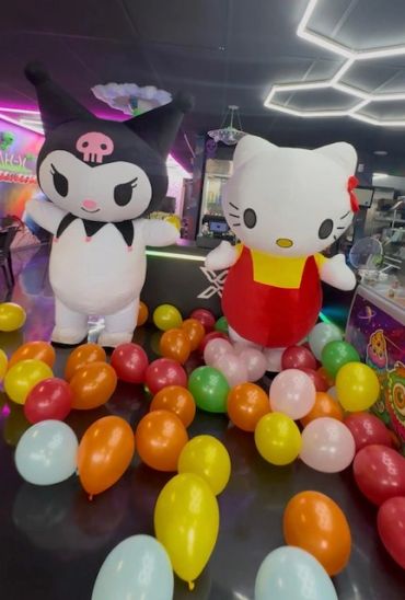 Hello Kitty and Kuromi balloon figures with colorful balloons around.