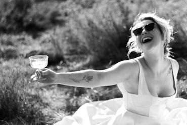 a bride in a wedding gown with champagne glass