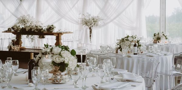 White Wedding tables for a Montreal Wedding by Eastwood Events. Wood tables, white flowers, ghost ch