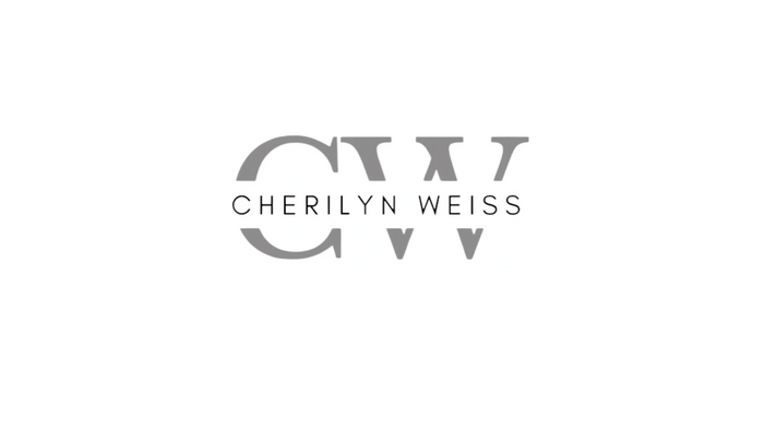 Stack of books next to pencils in a holder and a camera.