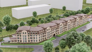 Architectural model of a large residential complex surrounded by greenery.