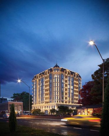 Elegant illuminated building at dusk with traffic in foreground.