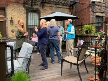Group of older adults socializing on a rooftop patio.