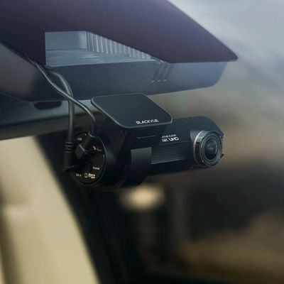 A BlackVue 4K UHD dashcam mounted inside a car.