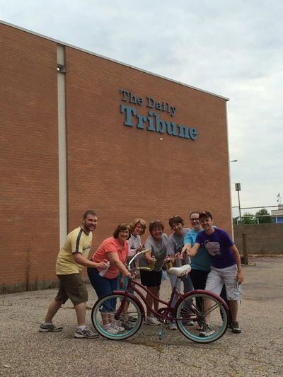 Group of Rotarians in front of The Daily Tribune building.