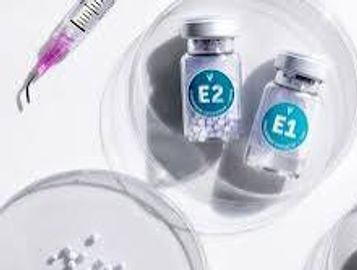 Two medicine vials labeled E1 and E2 with a syringe.