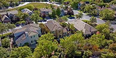 Aerial view of a suburban neighborhood with houses and greenery.
