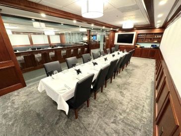 Elegant dining room with a long table set for a formal meal.