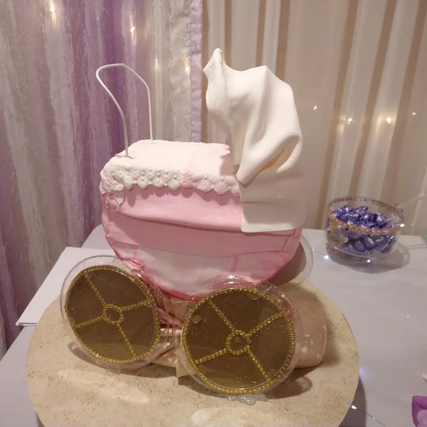 Yellow vanilla cake with buttercream frosting Baby carriage cake. 
