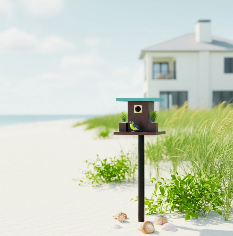 Modern handcrafted birdhouse featuring minimalist coastal design, photographed on a beach.