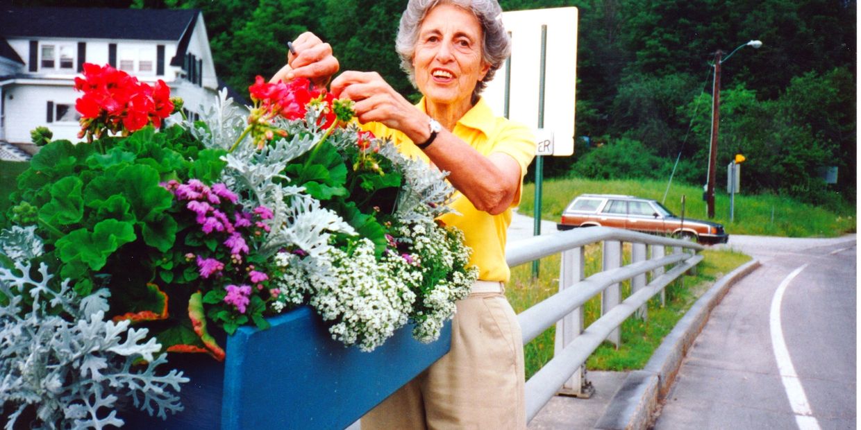 Elizabeth Welch (1920-2012) watering the Sugar Hill bridge boxes