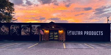 Storefront of Ultra Products at sunset with vibrant sky.