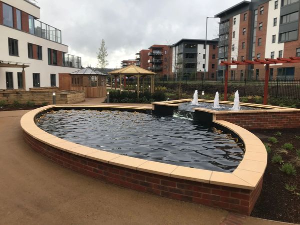 A fountain with brick walls