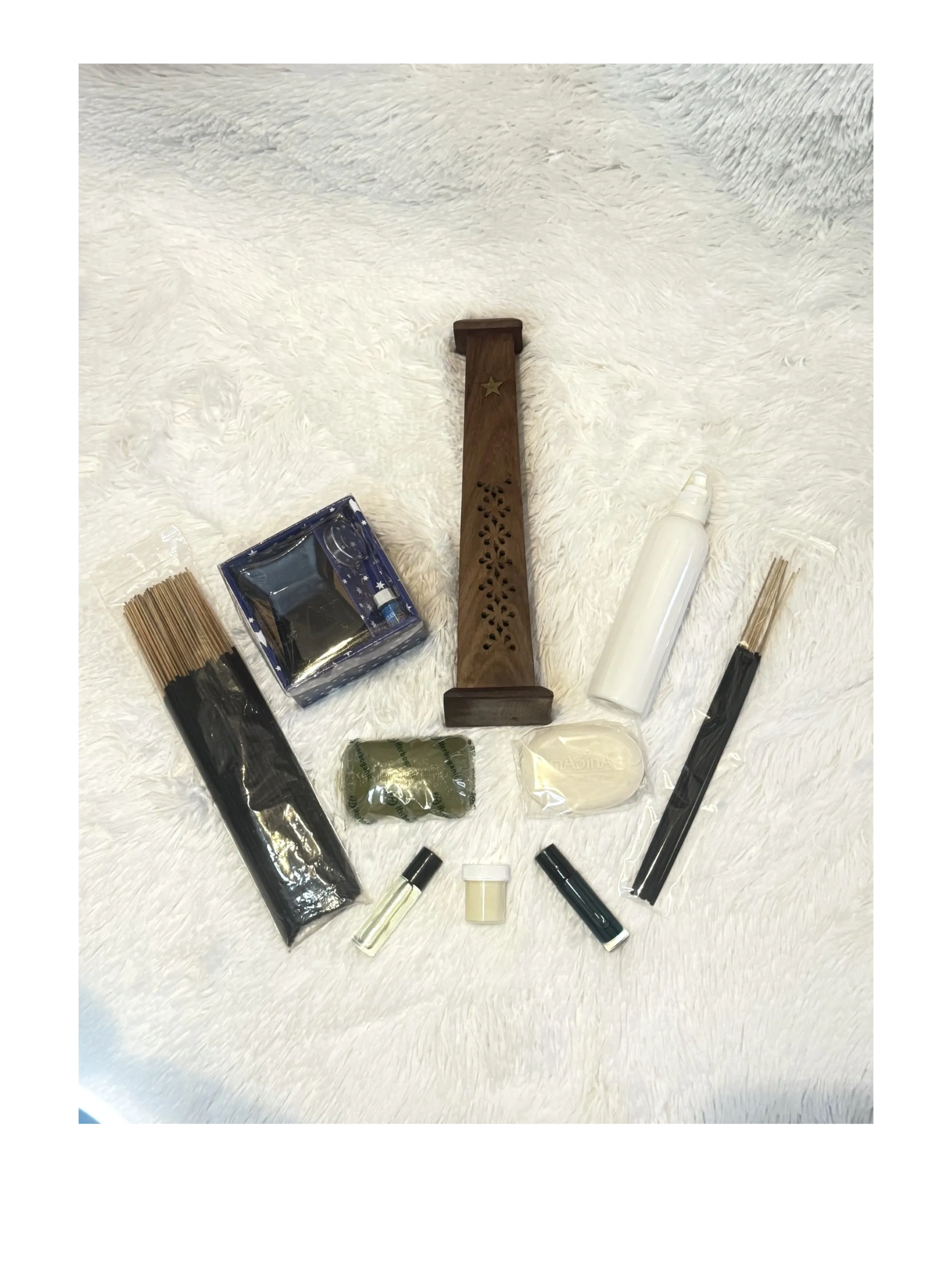 A collection of aromatherapy items including incense sticks and holders.