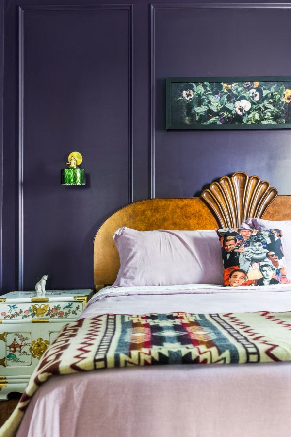Cozy vintage bedroom with patterned blanket and movie star pillow.