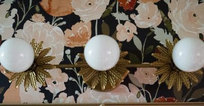Three round lights on floral patterned wall.