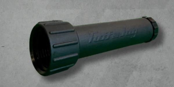 Dark green flashlight on a gray background.