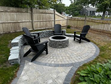 View of newly installed wood firepit and pavers